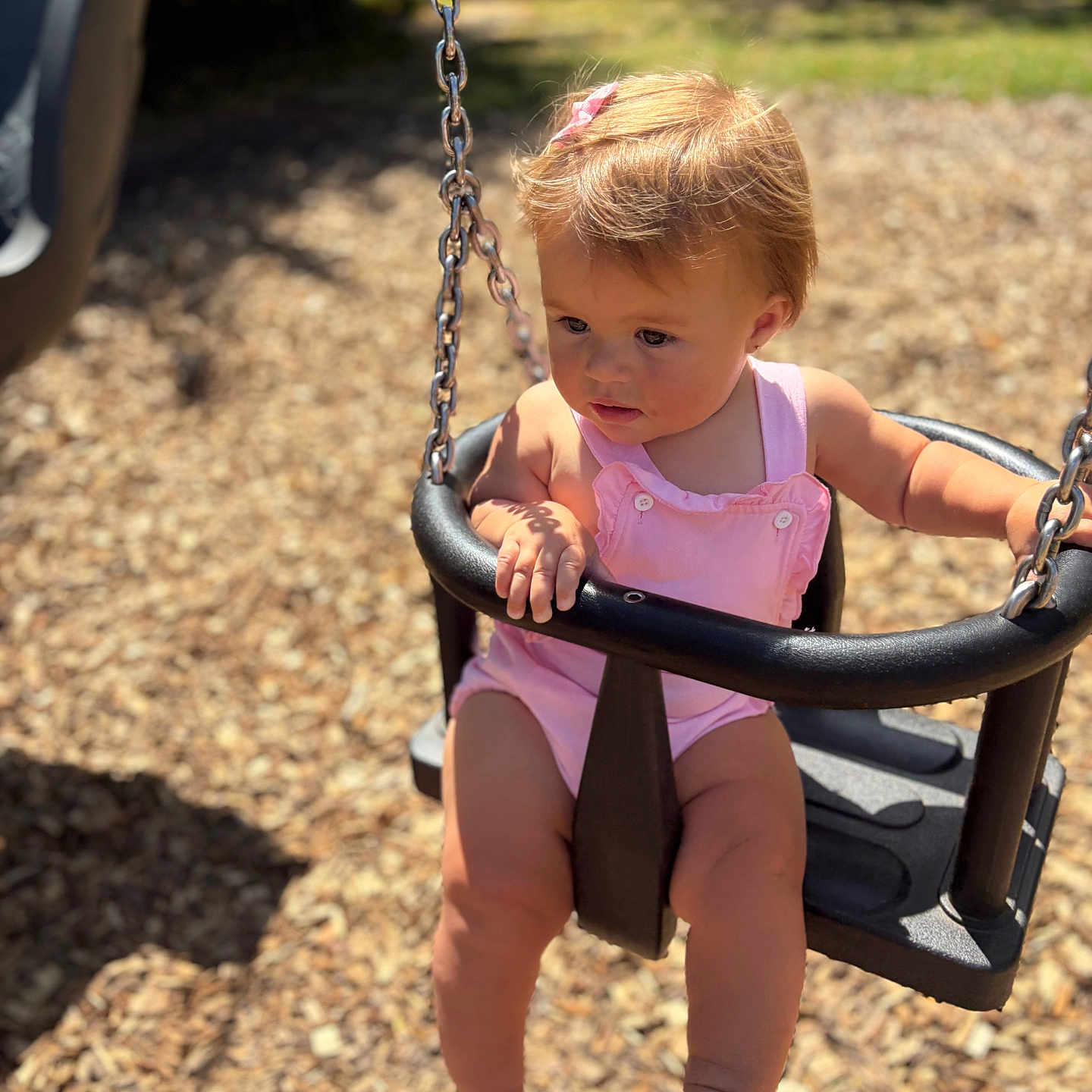 Nellie-Jayne is registered to the contest to win money with this photo: baby, barefoot, chain, child, cute, daylight, nature, outdoor, person, pink_clothing, playground, playtime, safety_bar, seat, summer, sunlight, swing, toddler, wood_chips, young_child