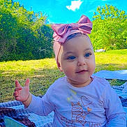 Derine participe au concours pour gagner de l'argent avec cette photo : baby, child, outdoor, blue_sky, greenery, headband, pink_bow, blanket, grass, sunny, cute, smiling, holding, toy, nature, daylight, sitting, happy, infant, playful