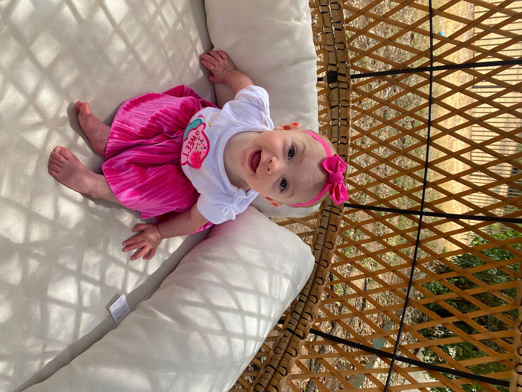 Charley is registered to the contest to win money with this photo: baby, baby_products, baby_safety, baby_toddler_clothing, child, comfort, fun, happy, leg, leisure, magenta, mesh, pattern, person, pink, recreation, smile, toddler, tree, wood
