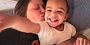 Roman joined the competition — help win amazing prizes! toddler, child, woman, smile, kiss, bed, pillow, striped_pillow, white_shirt, black_shirt, affection, happy, family, indoor, closeup, portrait, hand, person, emotion, love