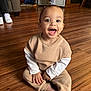Roman is registered to the contest to win money with this photo: toddler, baby, child, smiling, happy, indoor, wooden_floor, crawling, doorway, person, clothing, sitting, floor, feet, sneakers, adult, background, home, room, joy
