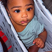Juelz joined the competition — help win amazing prizes! baby, child, curious, indoors, laundry_basket, patterned, peeking, cute, infant, clothing, skin, hand, portrait, expression, looking_up, closeup, person, young, playful, home