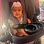 Miabelle is registered to the contest to win money with this photo: baby, child, smiling, stroller, headband, pink_bow, seatbelt, outdoor, sunlight, happy, infant, portrait, baby_clothes, cute, person, seat, hand, face, expression, baby_girl
