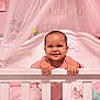 baby, crib, smile, pink, nursery, canopy, blanket, toy, child, infant, happy, person, bedroom, furniture, interior, cute, holding, standing, home, decor
