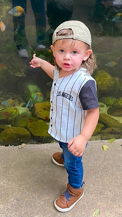 Liam is registered to the contest to win money with this photo: baby_toddler_clothing, baseball_cap, cap, child, cool, electric_blue, eye, eyewear, flash_photography, grass, happy, headwear, joint, lip, person, photograph, recreation, sleeve, street_fashion, t_shirt