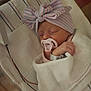 Makayla joined the competition — help win amazing prizes! newborn, baby, pacifier, hat, bow, blanket, sleeping, hospital, bassinet, infant, wrapped, cute, child, resting, soft_lighting, striped, pink, blue, cozy, peaceful