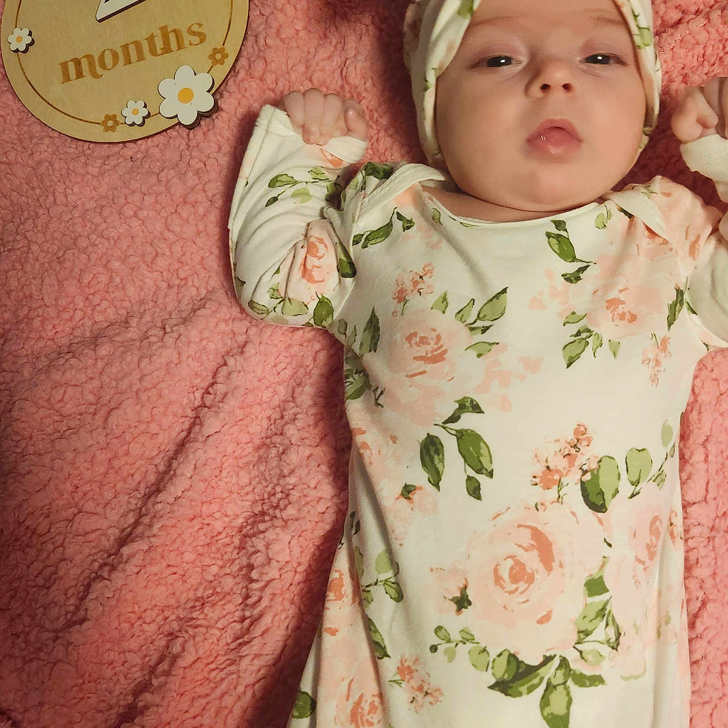 Makayla is registered to the contest to win money with this photo: age_marker, baby, celebration, child, cozy, cute, face, floral_clothing, hand, headband, indoors, infant, lying_down, milestone, newborn, pink_blanket, portrait, sleepy, soft_texture, wooden_plaque