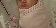 Makayla is registered to the contest to win money with this photo: newborn, baby, sleeping, swaddle, pink, hat, bow, crib, pacifier, clip, blanket, infant, cute, peaceful, face, person, closeup, indoors, resting, soft