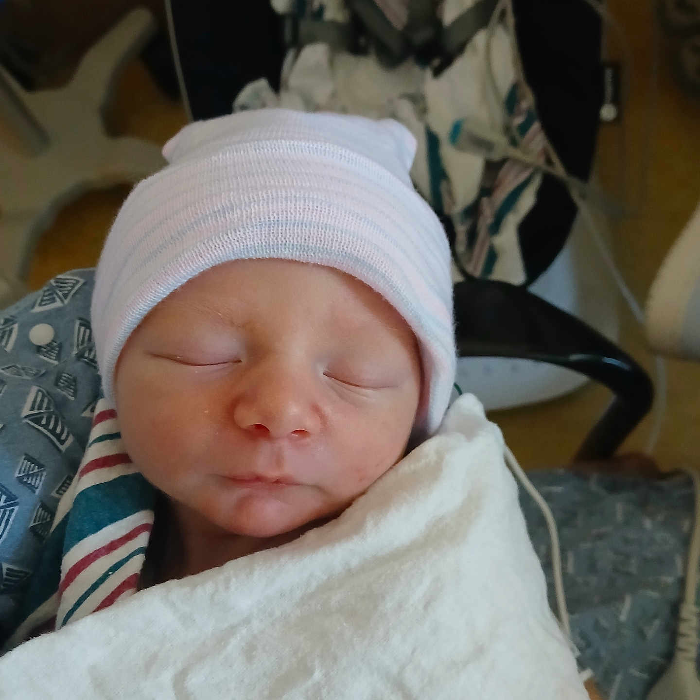 Issic is registered to the contest to win money with this photo: newborn, baby, sleeping, hat, blanket, hospital, medical, infant, face, closeup, peaceful, indoors, person, cute, child, swaddled, headwear, resting, newborn_baby, soft