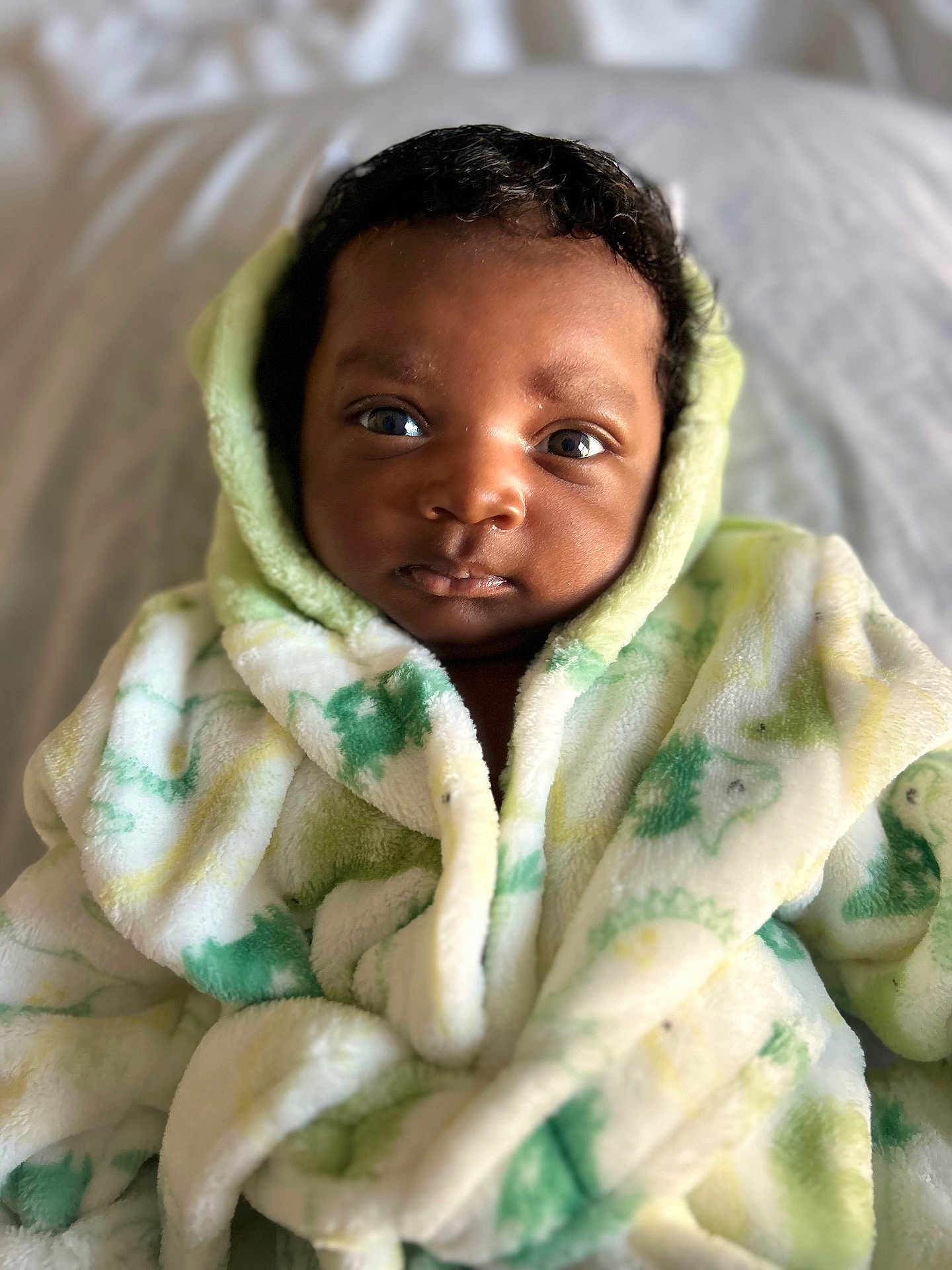 Jadon joined the competition — help win amazing prizes! baby, bed, blanket, blue_eyes, child, closeup, cozy, curly_hair, cute, face, fluffy_clothing, indoor, infant, looking_at_camera, portrait, robe, skin, soft_texture, warm, young_child