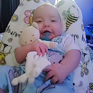 Michael joined the competition — help win amazing prizes! baby, blanket, blue, child, clothing, comfort, cozy, cute, face, hand, happy, home, indoor, infant, pattern, person, relaxed, smiling, soft_toy, toy