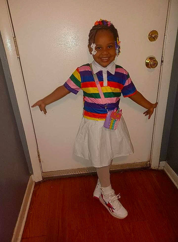 Jameirah joined the competition — help win amazing prizes! baby_toddler_clothing, child, costume, electric_blue, event, fashion_design, flooring, hardwood, human_leg, joy, knee, pattern, person, sandal, sleeve, smile, sock, sweatpant, t_shirt, toddler