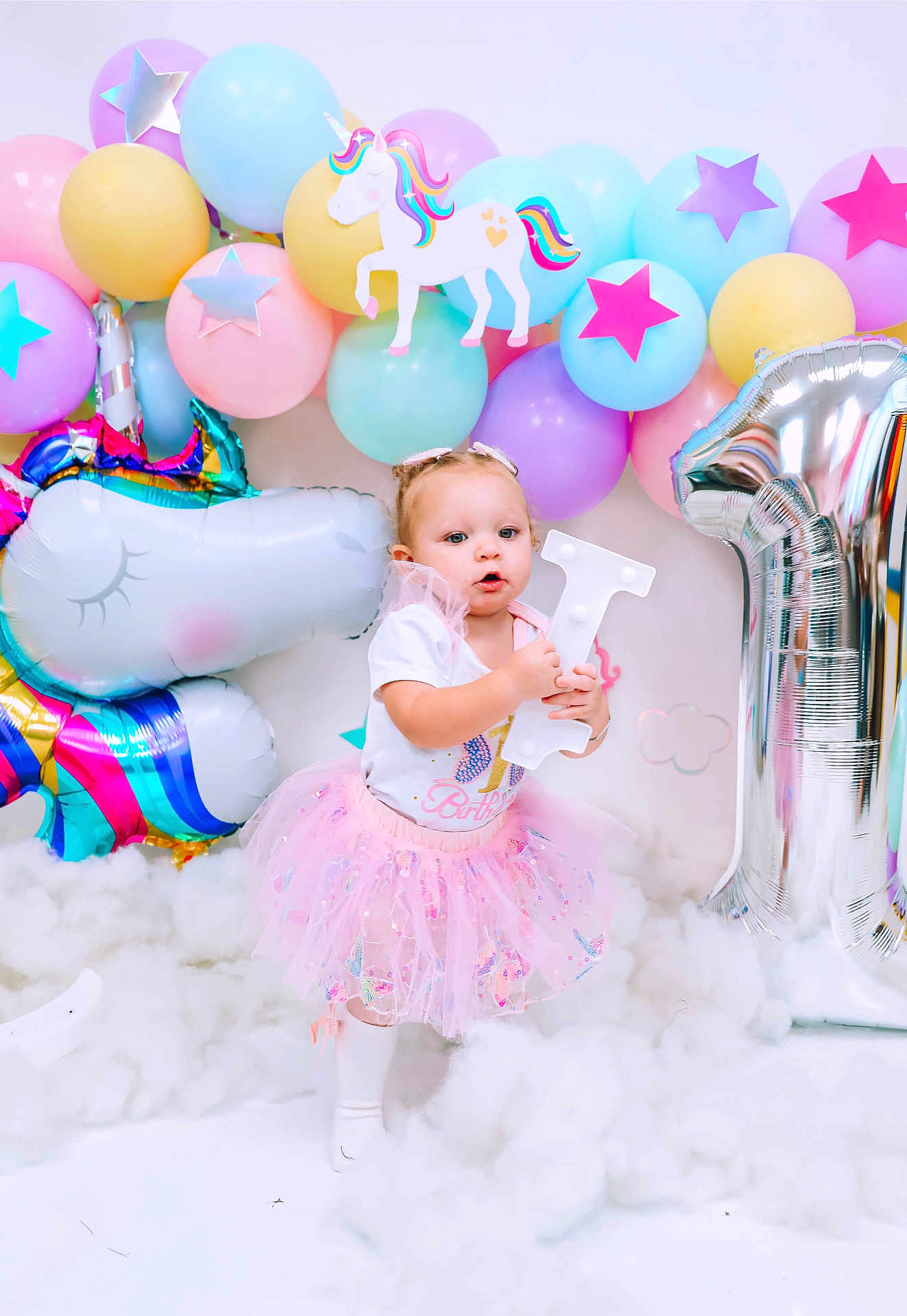Khloe is registered to the contest to win money with this photo: baby, balloon, bathing, bathtub, clothing, dress, face, fun, happy, head, party, people, person, photography, playarea, portrait, sitting, skirt, smile, tub