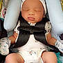 Zamari is registered to the contest to win money with this photo: baby, sleeping, car_seat, mittens, hat, infant, child, safety_straps, blue_cushion, white_clothing, newborn, peaceful, cute, soft, indoor, portrait, small_hands, small_feet, comfort, resting