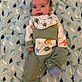 Isaac is registered to the contest to win money with this photo: apparel, baby, baby_garment, blanket, child, clothing, cozy, cute, dinosaur, face, green_outfit, indoors, infant, lying_down, pattern, playful, portrait, smiling, soft, young_child