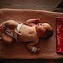 Riya joined the competition — help win amazing prizes! ankleband, baby, bassinet, blanket, cozy, cute, diaper, hospital, indoors, infant, knitted, lying_down, newborn, peaceful, personalized, portrait, red_cloth, sleeping, umbilical_clip, wristband