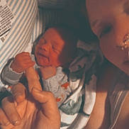 Preston is registered to the contest to win money with this photo: newborn, baby, adult, hand, finger, tattoo, face, skin, blanket, clothing, closeup, intimate, family, love, holding, person, portrait, indoor, sleepy, bond