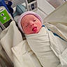 Preston joined the competition — help win amazing prizes! newborn, baby, hospital, blanket, swaddled, hat, medical_equipment, bassinet, infant, sleepy, face, person, cute, wrapped, healthcare, bed, white, pink, blue, soft