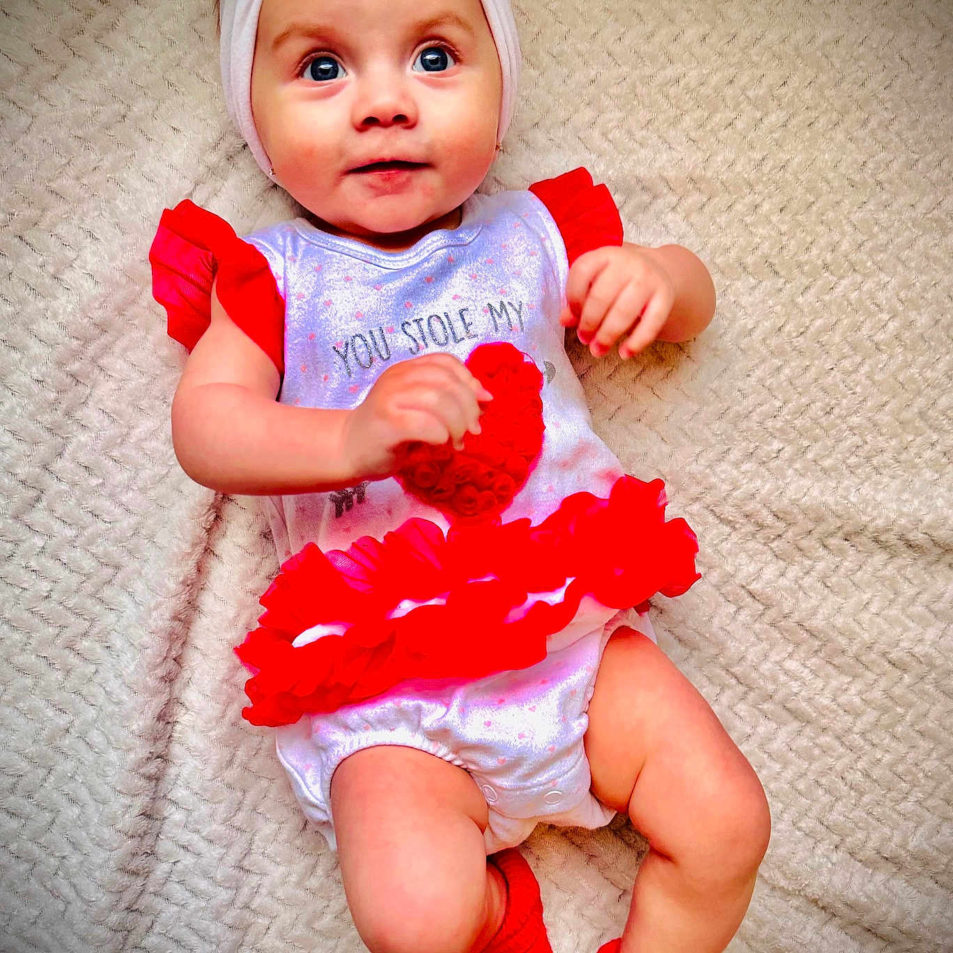 Alayna is registered to the contest to win money with this photo: accessories, baby, bed, blanket, bodypart, bonnet, cap, clothing, costume, couch, cushion, diaper, doll, dress, face, featherboa, finger, flower, flowerarrangement, flowerbouquet