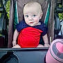 Ezekiel joined the competition — help win amazing prizes! baby, child, stroller, outdoor, grass, blue_eyes, curious_expression, red_clothing, navy_clothing, pink_cup, seat, tray, infant, face, person, sitting, summer, daylight, cute, portrait