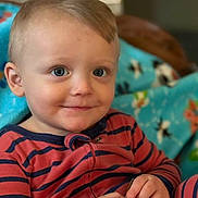 Malachi joined the competition — help win amazing prizes! toddler, child, boy, smile, blue_eyes, striped_clothing, hands, indoor, blanket, cozy, portrait, cute, face, sitting, young_child, baby, comfort, furniture, happy, casual