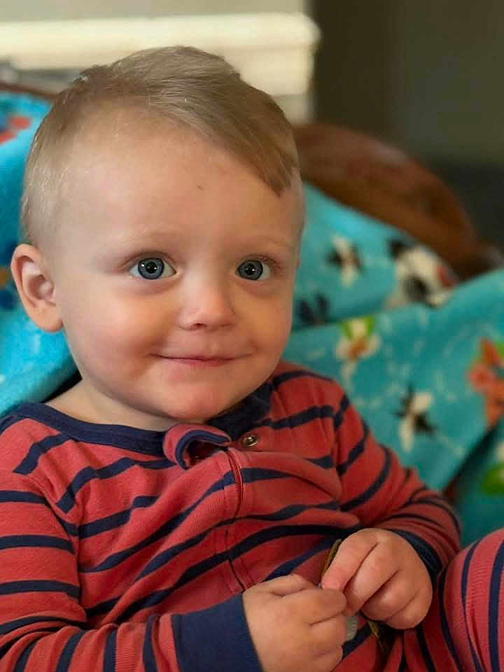 Malachi joined the competition — help win amazing prizes! toddler, child, boy, smile, blue_eyes, striped_clothing, hands, indoor, blanket, cozy, portrait, cute, face, sitting, young_child, baby, comfort, furniture, happy, casual