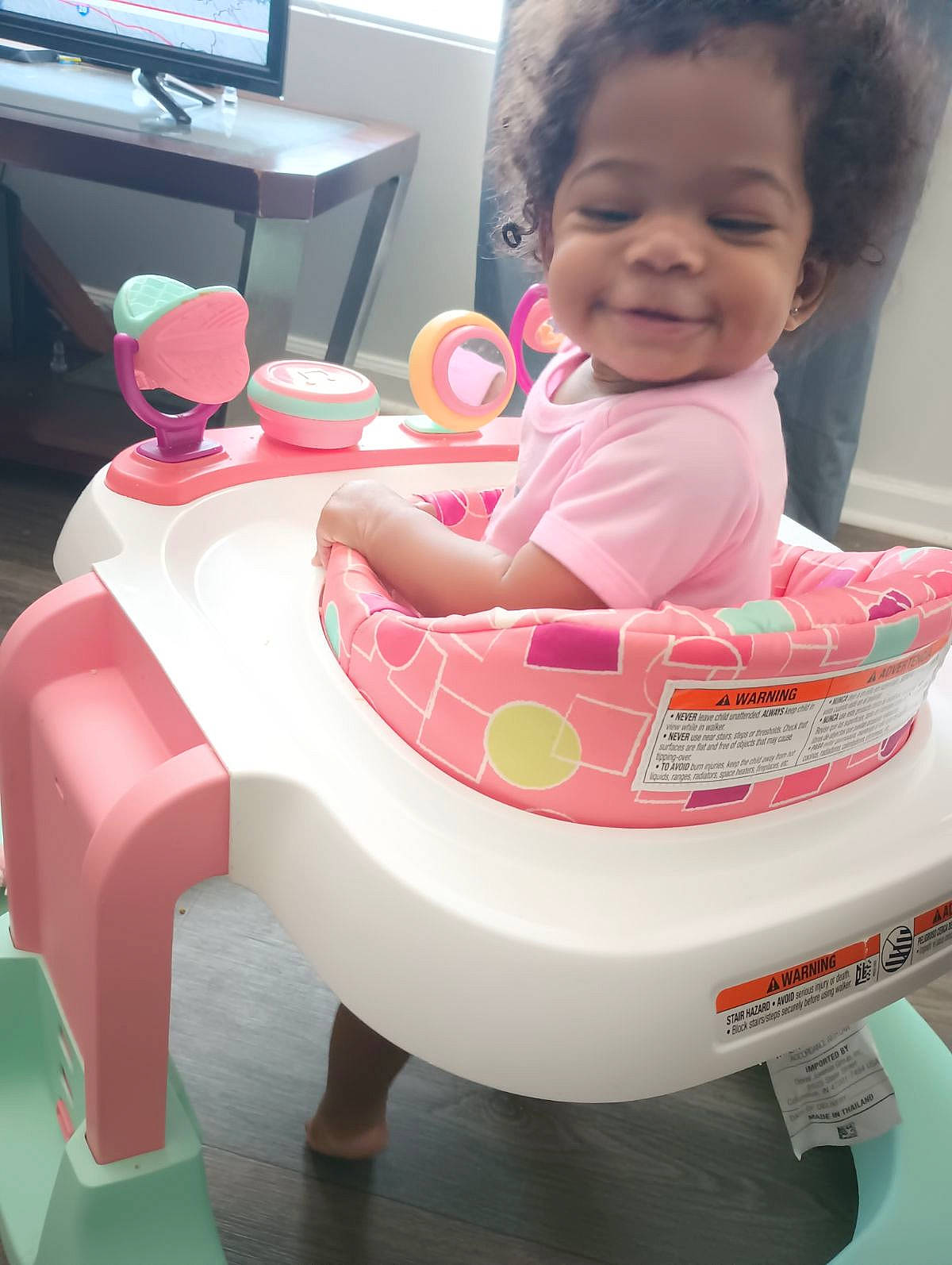 Shyla is registered to the contest to win money with this photo: baby, baby_products, baby_toddler_clothing, carmine, child, comfort, computer_keyboard, fun, happy, joy, lap, magenta, peripheral, person, pink, plastic, sitting, skin, smile, television