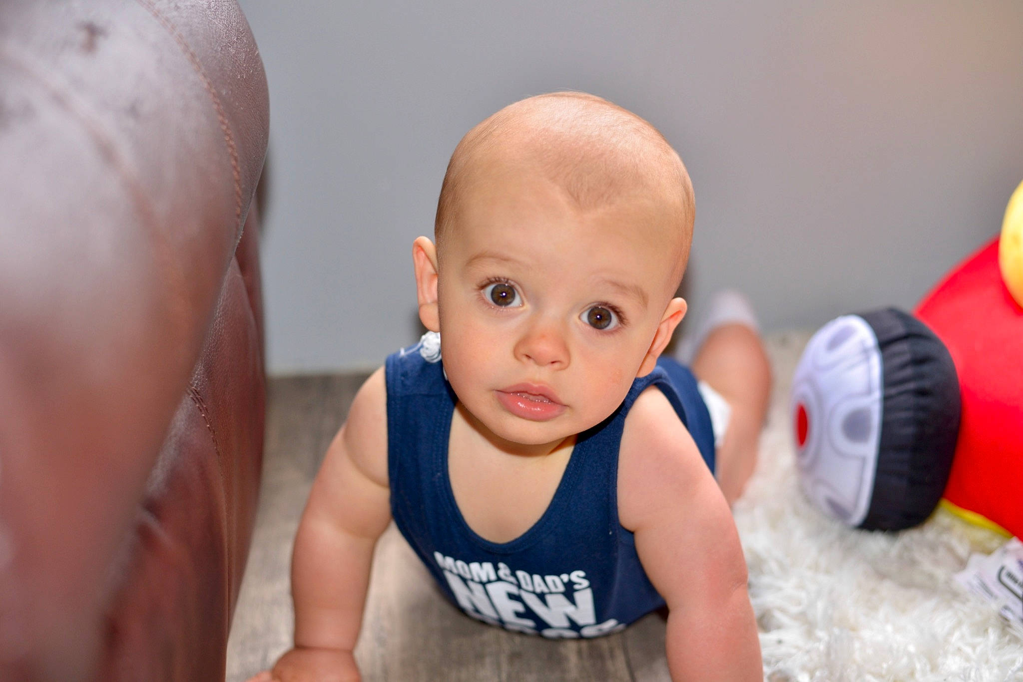 Brody is registered to the contest to win money with this photo: abdomen, baby, baby_toddler_clothing, cheek, chest, child, close_up, eye, eyelash, flooring, fun, happy, joint, mouth, nose, person, smile, toddler, toy, trunk