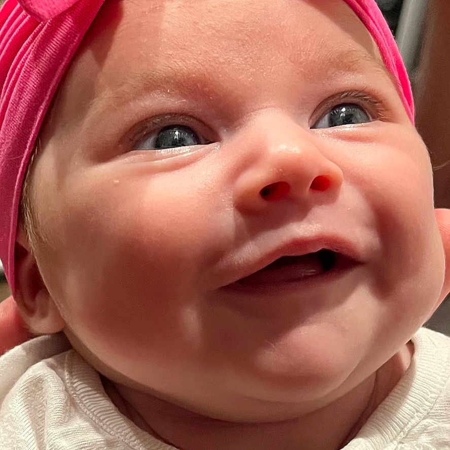 Ivory-Mae is registered to the contest to win money with this photo: accessories, baby, babylaughing, bodypart, bonnet, cap, clothing, face, happy, hat, head, headband, laughing, mouth, newborn, person, photography, portrait, smile, t_shirt