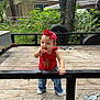 Jo Eva joined the competition — help win amazing prizes! toddler, child, red_headband, red_top, jeans, white_shoes, wooden_deck, black_railing, tree, greenery, tire, rustic_house, outdoor, curious_expression, standing, daylight, casual_clothing, nature, baby, playful