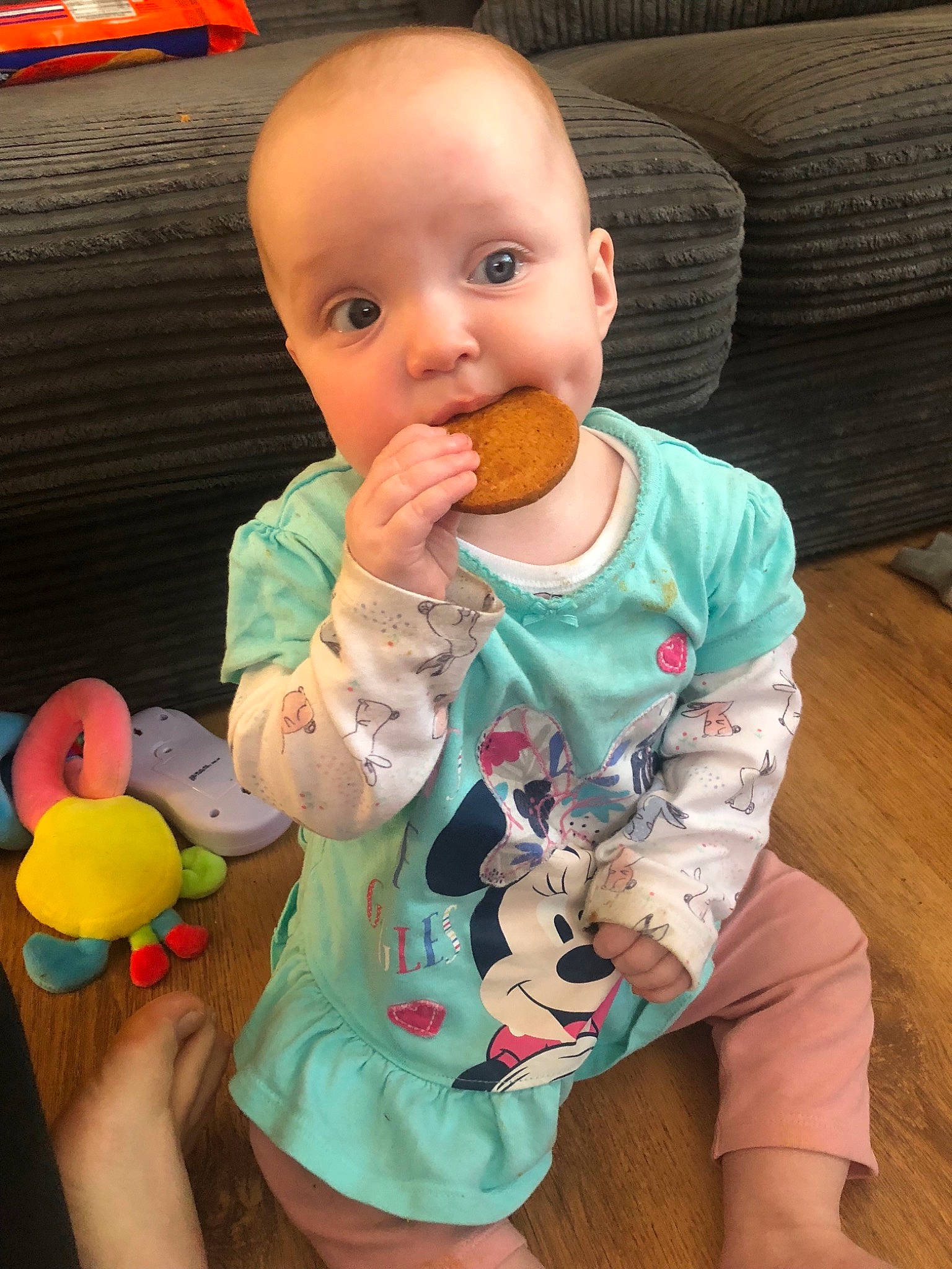 Sydney is registered to the contest to win money with this photo: baby, baby_toddler_clothing, cheek, child, eating, person, play, sitting, toddler