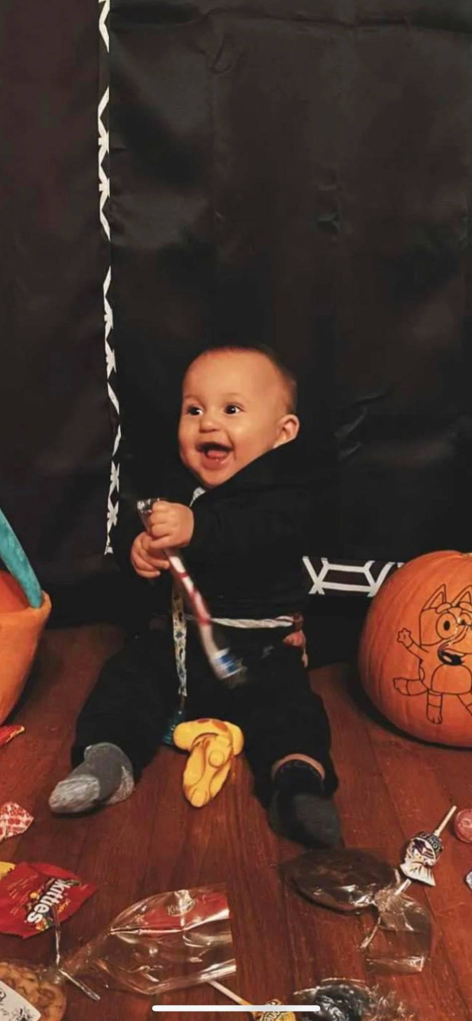 Asher is registered to the contest to win money with this photo: baby, ball, calabaza, child, flash_photography, flooring, fun, gourd, hand, happy, human_body, human_leg, person, pumpkin, sitting, smile, sports_equipment, thumb, toddler, winter_squash