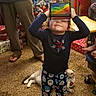 child, toddler, smiling, portrait, indoor, christmas, christmas_tree, holiday, gifts, wrapped presents, dog, pet, rainbow, toy, playful, funny, standing, pajamas, family, home