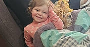 Aryatanner joined the competition — help win amazing prizes! child, toddler, girl, smiling, portrait, dog, pet, blanket, couch, indoors, family, cozy, sitting, playful, salute, long_hair, pink_shirt, home, wood_floor, candid