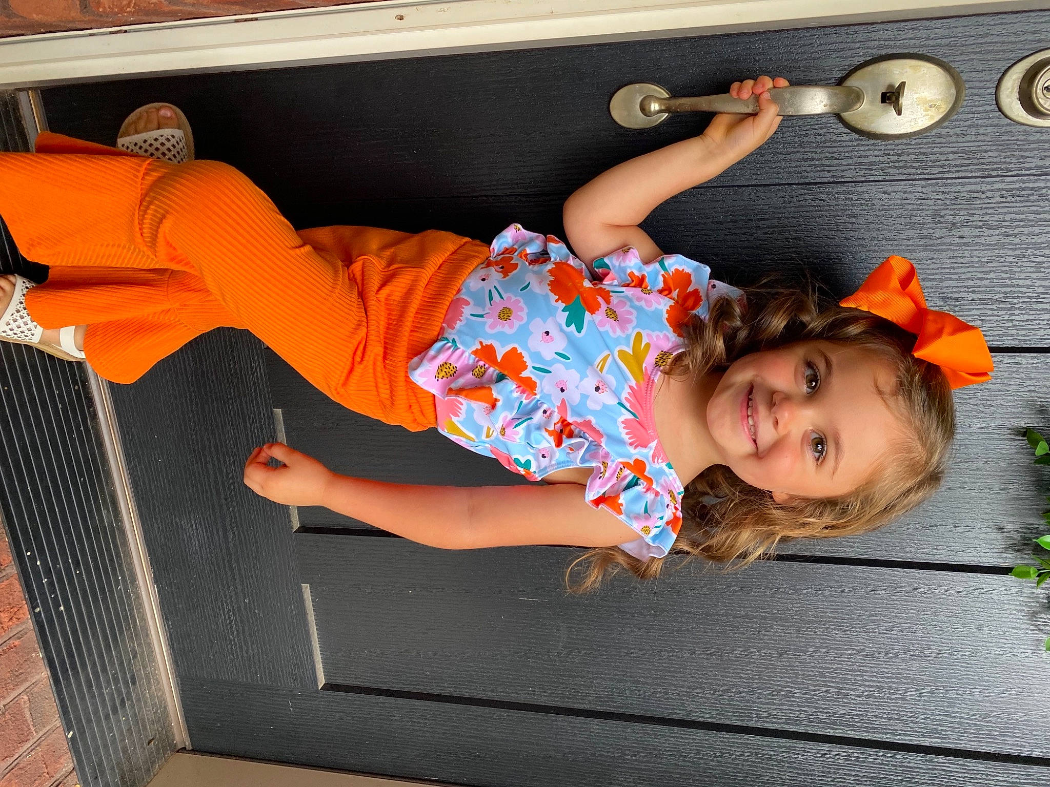 Teagan is registered to the contest to win money with this photo: baby_toddler_clothing, child, comfort, flooring, fun, happy, human_leg, joy, knee, leg, leisure, person, play, room, shoe, shorts, sitting, smile, t_shirt, thigh