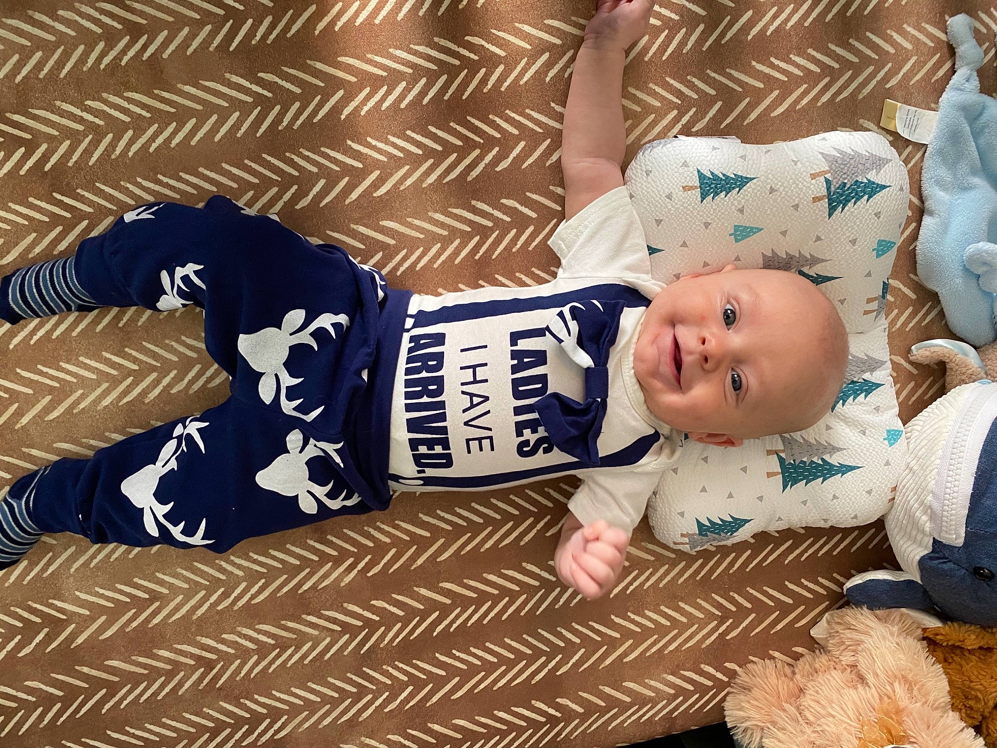 Keelan joined the competition — help win amazing prizes! baby, baby_toddler_clothing, child, comfort, flooring, hand, happy, hat, head, human_body, linens, pattern, person, sitting, skin, sleeve, smile, t_shirt, textile, toddler
