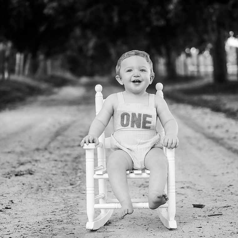 Augustus is registered to the contest to win money with this photo: baby, chair, city, face, furniture, grass, head, nature, outdoors, park, person, photography, plant, portrait, road, sitting, street, tree, urban, vegetation