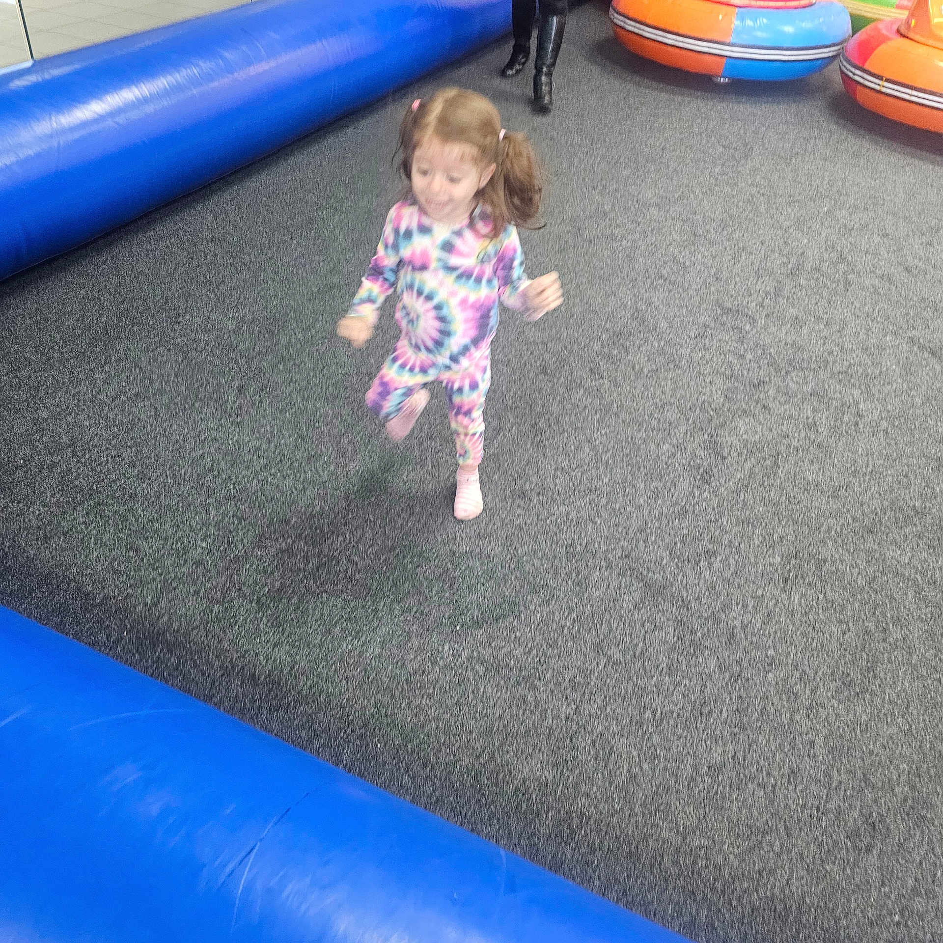 Taghrid Aljboor joined the competition — help win amazing prizes! child, toddler, pajamas, tie_dye, indoor, play_area, carpet, inflatable, blue, running, motion_blur, person, fun, active, footwear, pink, hair, pigtails, kid, jumping