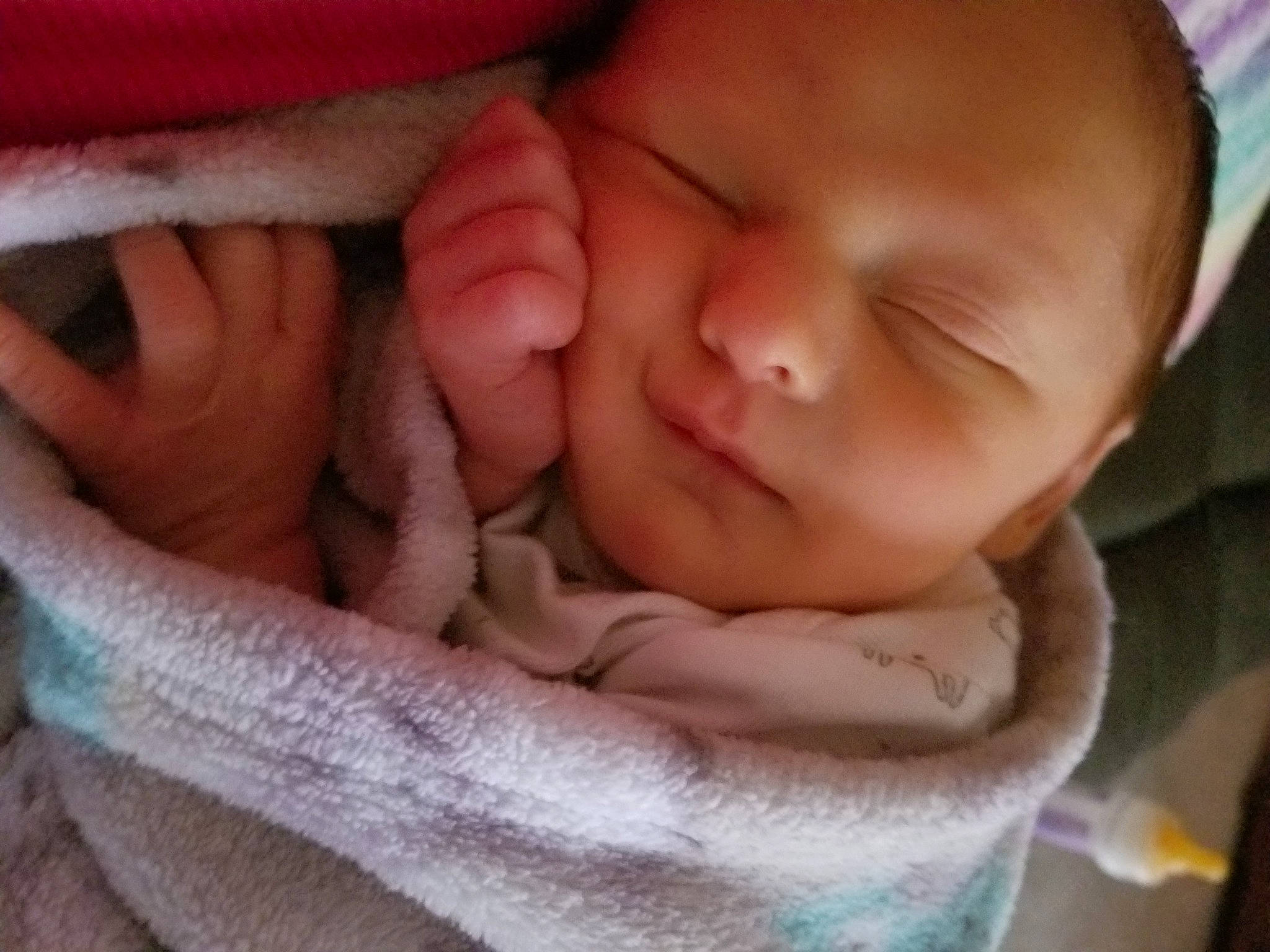 Liam is registered to the contest to win money with this photo: baby, cheek, chin, close_up, comfort, eyebrow, eyelash, face, finger, gesture, happy, lip, mouth, nail, nose, person, skin, smile, textile, thumb