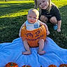 baby, child, sibling, sister, pumpkin, halloween, costume, outdoor, park, grass, blanket, portrait, smiling, sitting, crouching, family, autumn, sunlight, decorated_pumpkins, playful