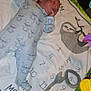 baby, sleeping, onesie, milestone_blanket, sloth, numbers, toy, colorful, infant, cute, peaceful, child, soft, blanket, pattern, cartoon, lying_down, indoors, playmat, newborn