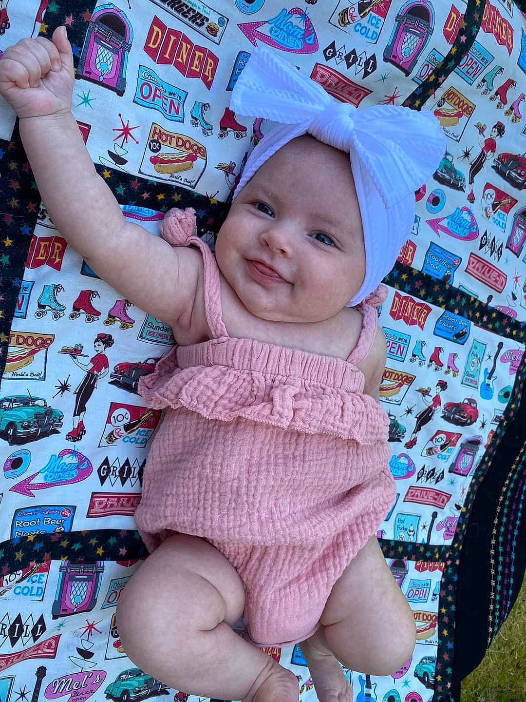 Evelynn is registered to the contest to win money with this photo: art, baby, baby_products, baby_toddler_clothing, blue, cheek, child, foot, fun, gesture, happy, headwear, linens, magenta, pattern, person, pink, skin, sleeve, smile