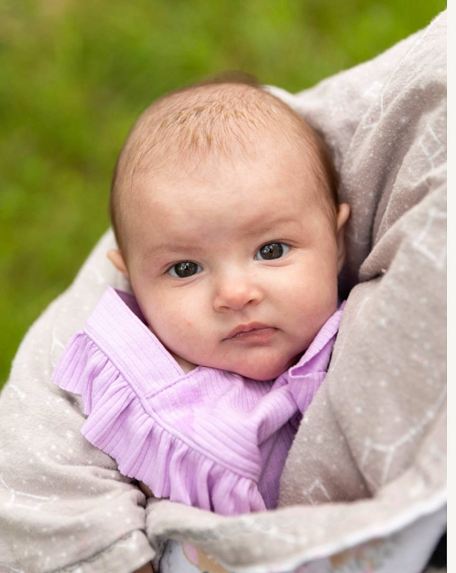 Evelynn is registered to the contest to win money with this photo: baby, baby_products, baby_toddler_clothing, cheek, child, comfort, grass, happy, linens, person, pink, portrait_photography, sitting, sleeve, toddler