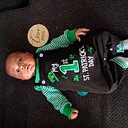 Kei'Vontay joined the competition — help win amazing prizes! baby, infant, child, onesie, st_patricks_day, green_clothing, striped_sleeves, socks, wooden_month_marker, two_months, carpet, lying_down, portrait, cute, portrait_baby, face, hand, foot, pacifier, button