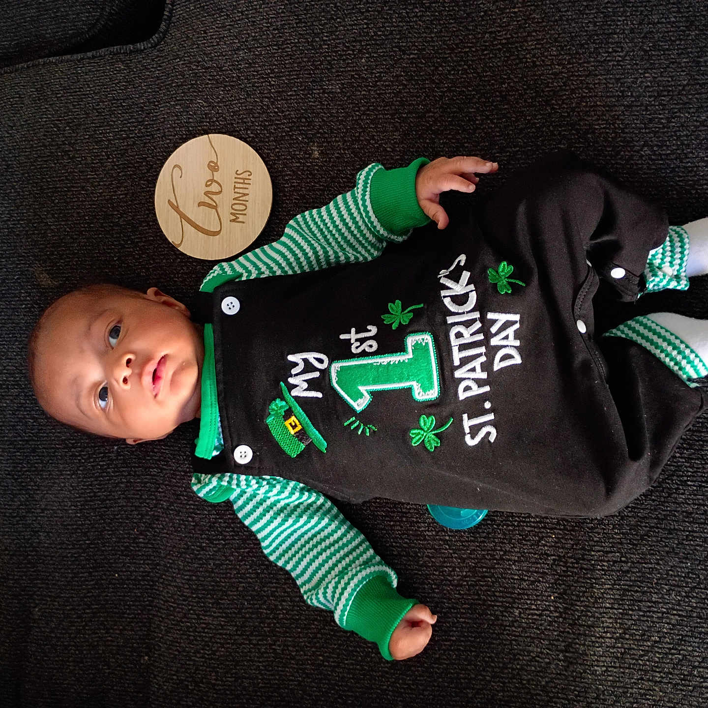 Kei'Vontay joined the competition — help win amazing prizes! baby, button, carpet, child, cute, face, foot, green_clothing, hand, infant, lying_down, onesie, pacifier, portrait, portrait_baby, socks, st_patricks_day, striped_sleeves, two_months, wooden_month_marker