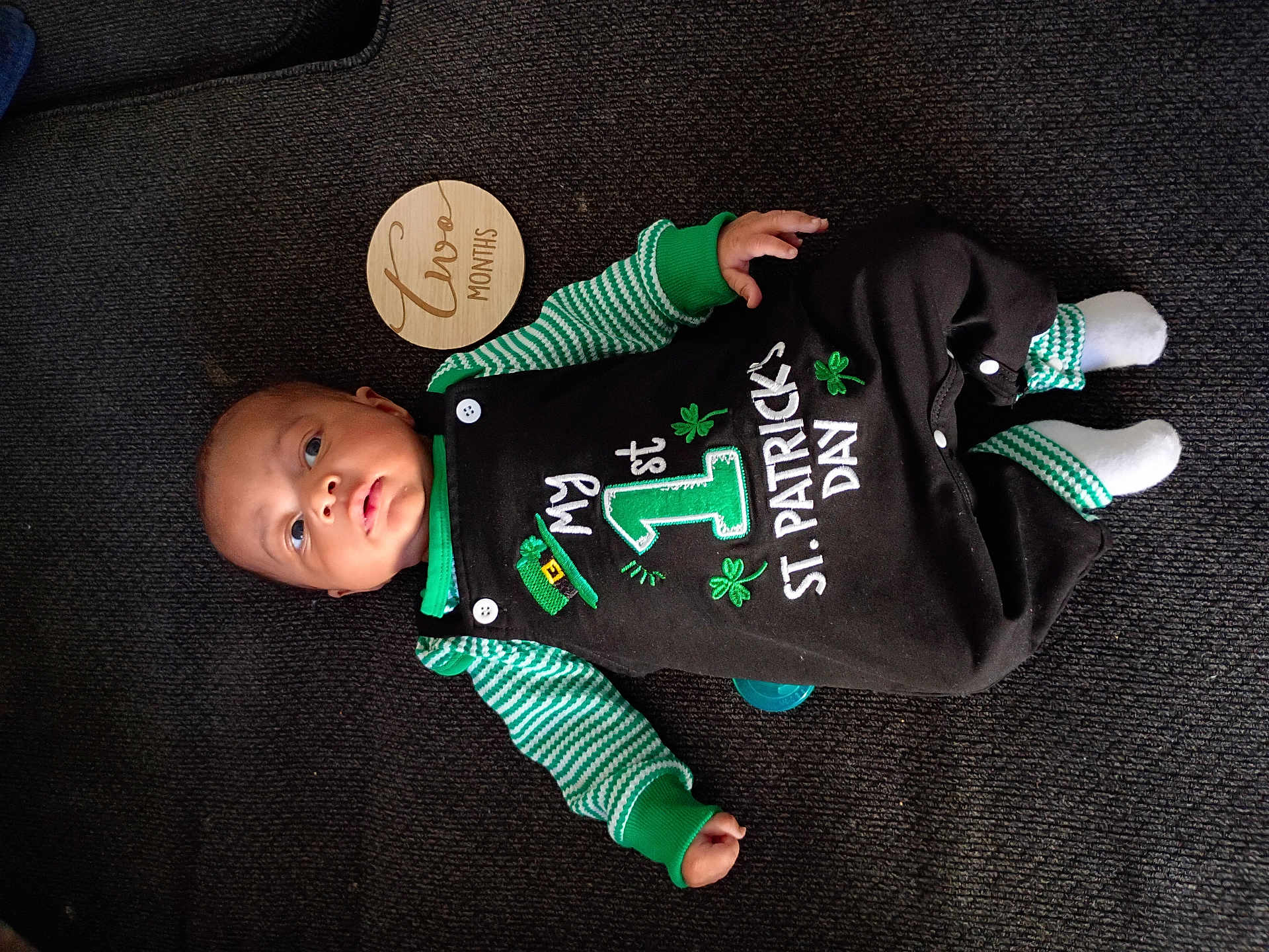 Kei'Vontay joined the competition — help win amazing prizes! baby, infant, child, onesie, st_patricks_day, green_clothing, striped_sleeves, socks, wooden_month_marker, two_months, carpet, lying_down, portrait, cute, portrait_baby, face, hand, foot, pacifier, button