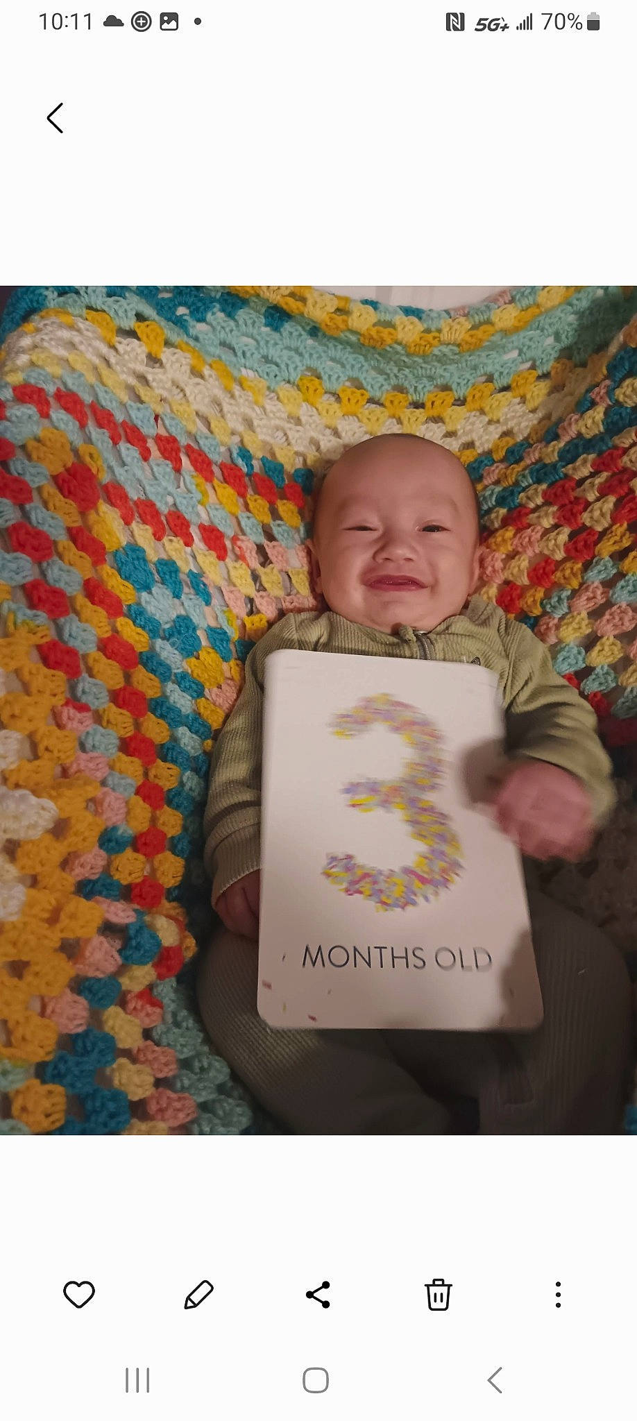 Avery is registered to the contest to win money with this photo: baby, baby_toddler_clothing, bedtime, book, cheek, child, comfort, happy, joy, linens, orange, pattern, person, room, sitting, sleeve, smile, t_shirt, toddler, wool