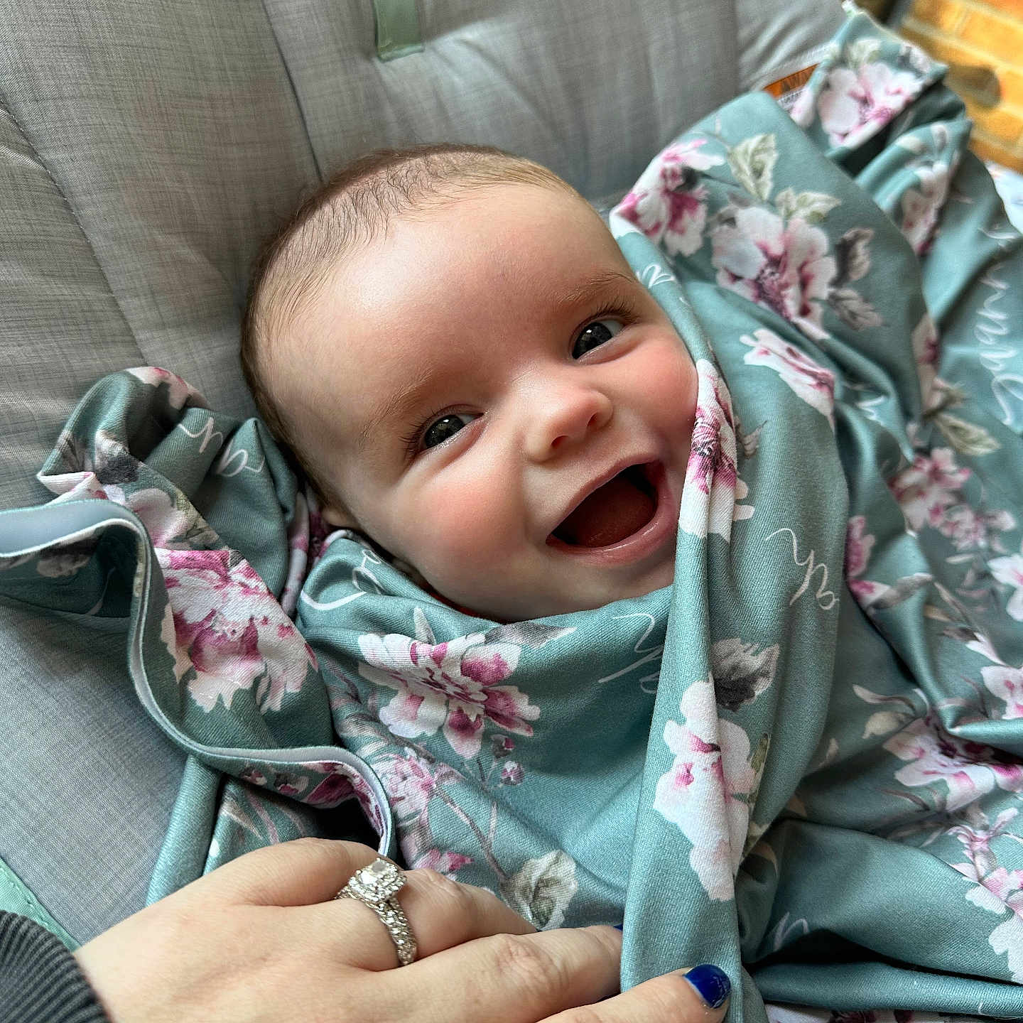 Savannah is registered to the contest to win money with this photo: accessories, baby, blanket, bodypart, clothing, coat, crib, diamond, face, finger, furniture, gemstone, hand, head, jacket, jewelry, person, photography, portrait, ring