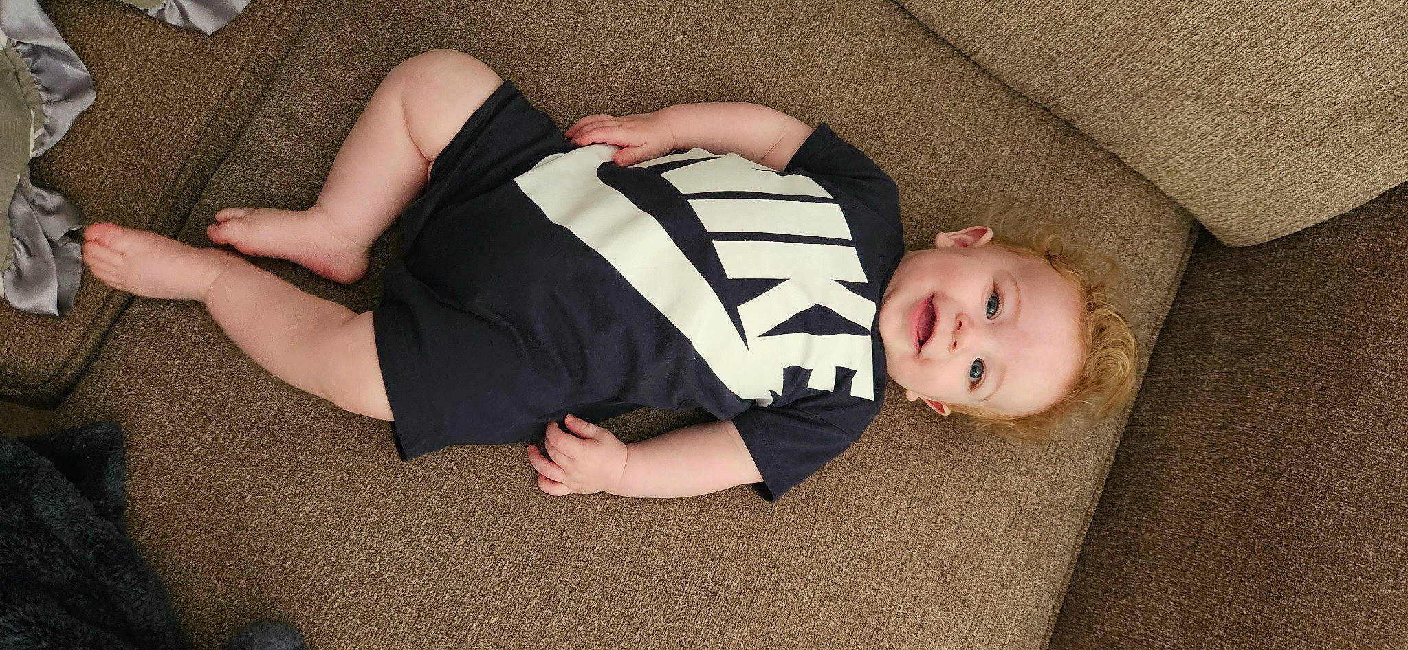 Colton is registered to the contest to win money with this photo: baby_toddler_clothing, comfort, elbow, finger, flooring, foot, human_body, human_leg, joint, joy, knee, lap, pattern, person, sitting, sleeve, thigh, toddler, trunk, waist