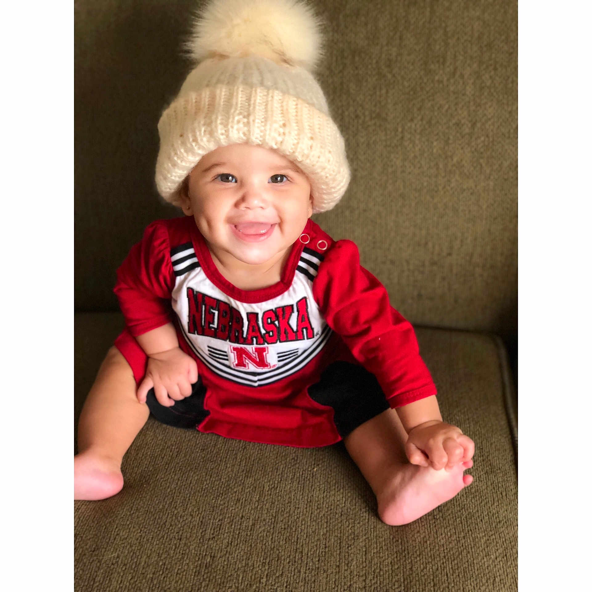 Kylynn is registered to the contest to win money with this photo: beanie, bonnet, cap, child, fur, hat, headgear, infant, joy, knit_cap, person, product, sleeve, smile, textile, toddler, wool